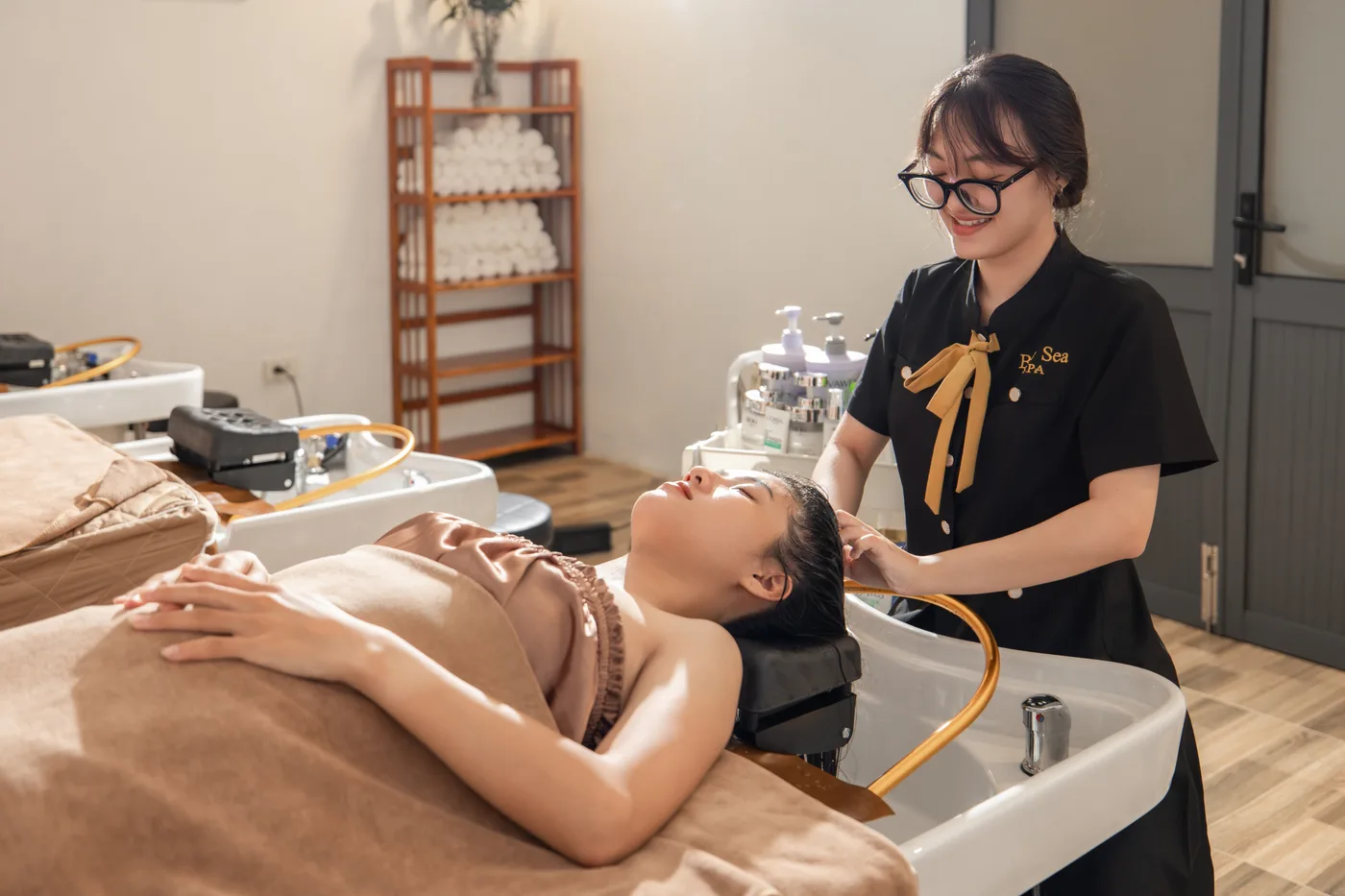 A therapist washing a guest’s hair