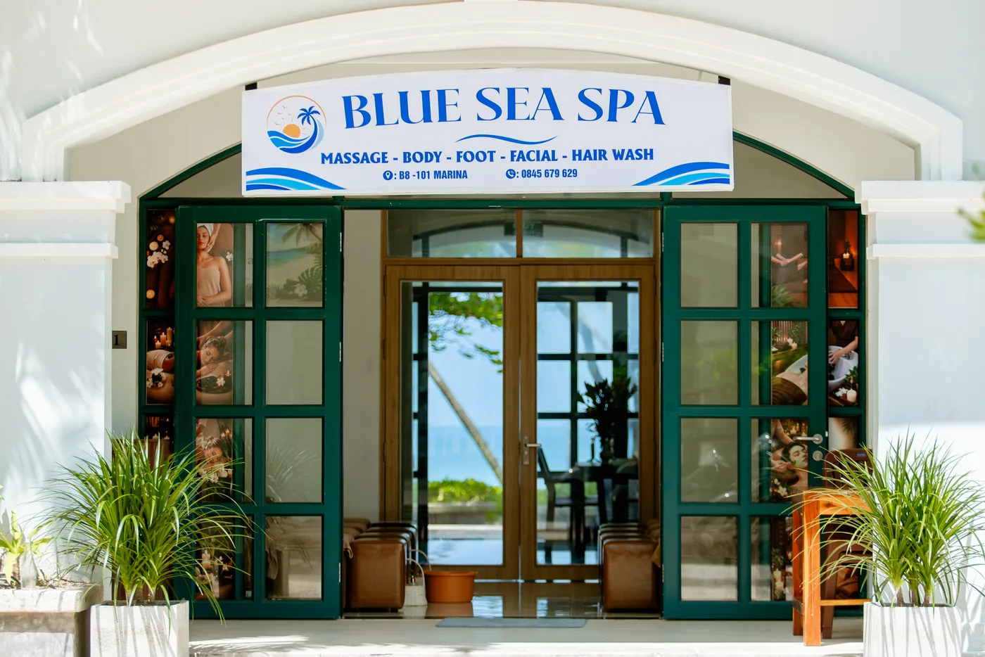 The Blue Sea Spa entrance with its blue sign and green doors